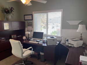 Office/Bedroom area featuring a ceiling fan and a wainscoted wall