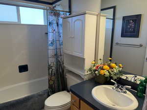 Bathroom with vanity and shower / tub combo