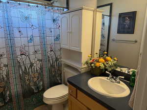 Bathroom with vanity and tiled shower