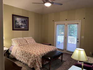 Primary Bedroom featuring dark colored carpet, access to outside, and ceiling fan