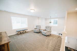 Living area featuring carpet, a ceiling fan, and recessed lighting