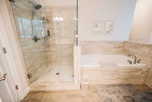 Full bath featuring a garden tub and a stall shower