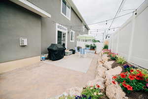 Fenced backyard featuring a patio and grilling area