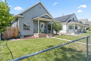 View of front facade with a fenced front yard and covered porch