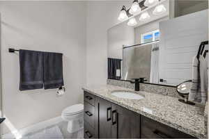 Bathroom featuring vanity and a tile shower