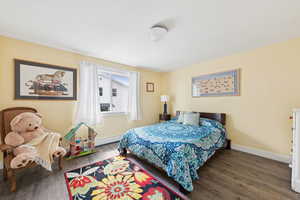 Bedroom featuring dark wood-style flooring