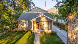 View of front of property with  covered porch and mountain view (visible from interior of home through large picture window in 2nd floor flex space)
