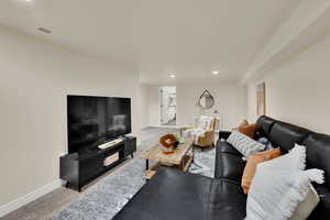 Stairs to basement family room after dining area with view of laundry room