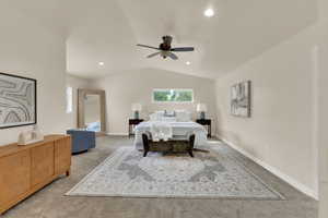 Spacious primary bedroom with vaulted ceiling