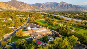 Bird's eye view of a mountainous background and country club golf course