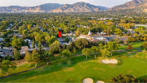 Aerial view of residential area featuring mountains and country club golf course