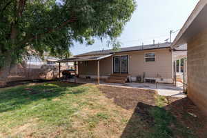 Rear view of house featuring a patio and entry steps