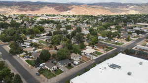 Aerial overview of property's location with nearby suburban area and a mountainous background