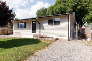 View of front of property with a gate and a patio area
