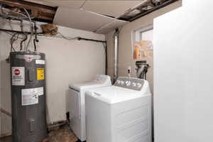 Laundry area with water heater and washer and dryer