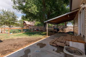 Fenced backyard with a patio