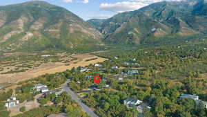 Aerial view of property and surrounding area featuring mountains
