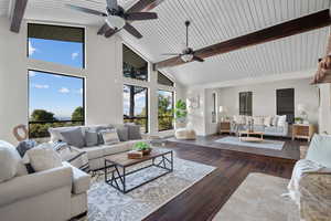 Living room featuring high vaulted ceiling, beam ceiling, and dark wood finished floors