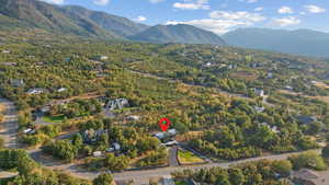 Aerial view of property's location with a mountainous background