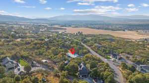 Aerial view of property and surrounding area with a mountainous background