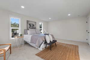 Bedroom featuring light carpet and recessed lighting