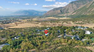 Aerial view of property and surrounding area featuring mountains