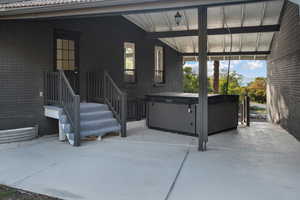 View of patio featuring a hot tub
