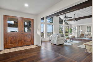 Foyer entrance with beamed ceiling, dark wood finished floors, high vaulted ceiling, and ceiling fan