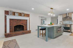Kitchen featuring backsplash, green cabinets, a breakfast bar, white cabinetry, and high end stove