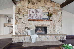 Living area featuring wood ceiling, wood finished floors, and a fireplace