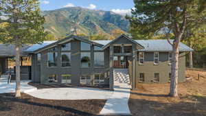 Modern home with brick siding, a mountain view, a metal roof, and a standing seam roof