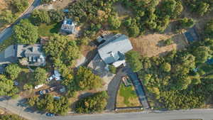 View of property location featuring a tree filled landscape