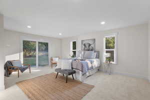 Bedroom featuring light carpet, recessed lighting, and access to exterior