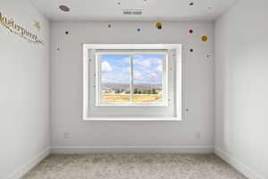 Unfurnished room with light carpet and baseboards