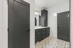 Bathroom with vanity and light tile patterned floors