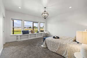 Carpeted bedroom with recessed lighting, a mountain view, and a chandelier