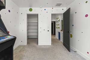 Bedroom featuring light carpet