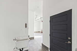 Bathroom with a sink and unfinished concrete floors