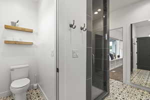 Full bath with tile patterned flooring and a shower stall