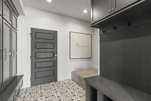 Mudroom with recessed lighting and light tile patterned floors