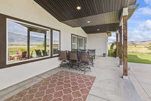 View of patio with a mountain view and outdoor dining area