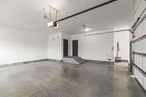 Garage featuring a garage door opener