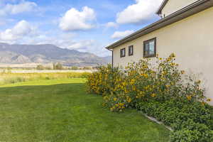 View of grassy yard featuring a mountain view