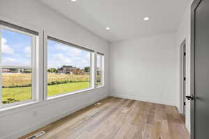 Unfurnished room with recessed lighting and light wood-type flooring