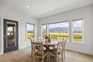 Dining space featuring recessed lighting, light wood-type flooring, and a mountain view