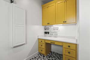 Office with built in study area and tile patterned floors