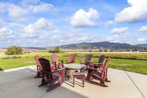 View of patio / terrace featuring a mountain view and an outdoor fire pit