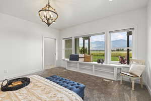 Bedroom with a mountain view, carpet floors, and a chandelier