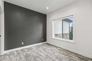 Unfurnished room featuring baseboards and recessed lighting
