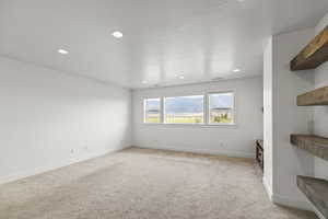 Spare room featuring light carpet and recessed lighting